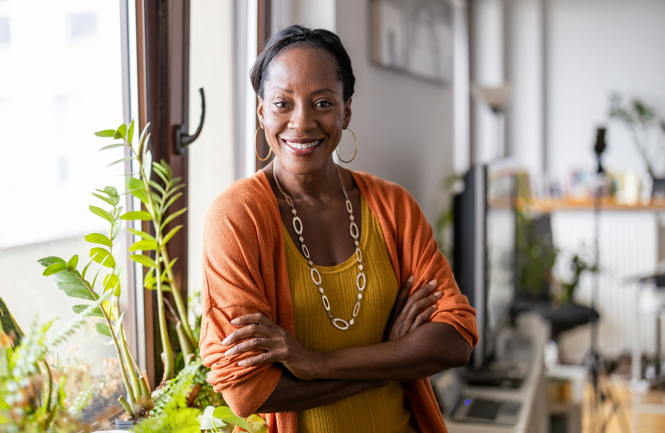 smiling mature woman standing in her apartment