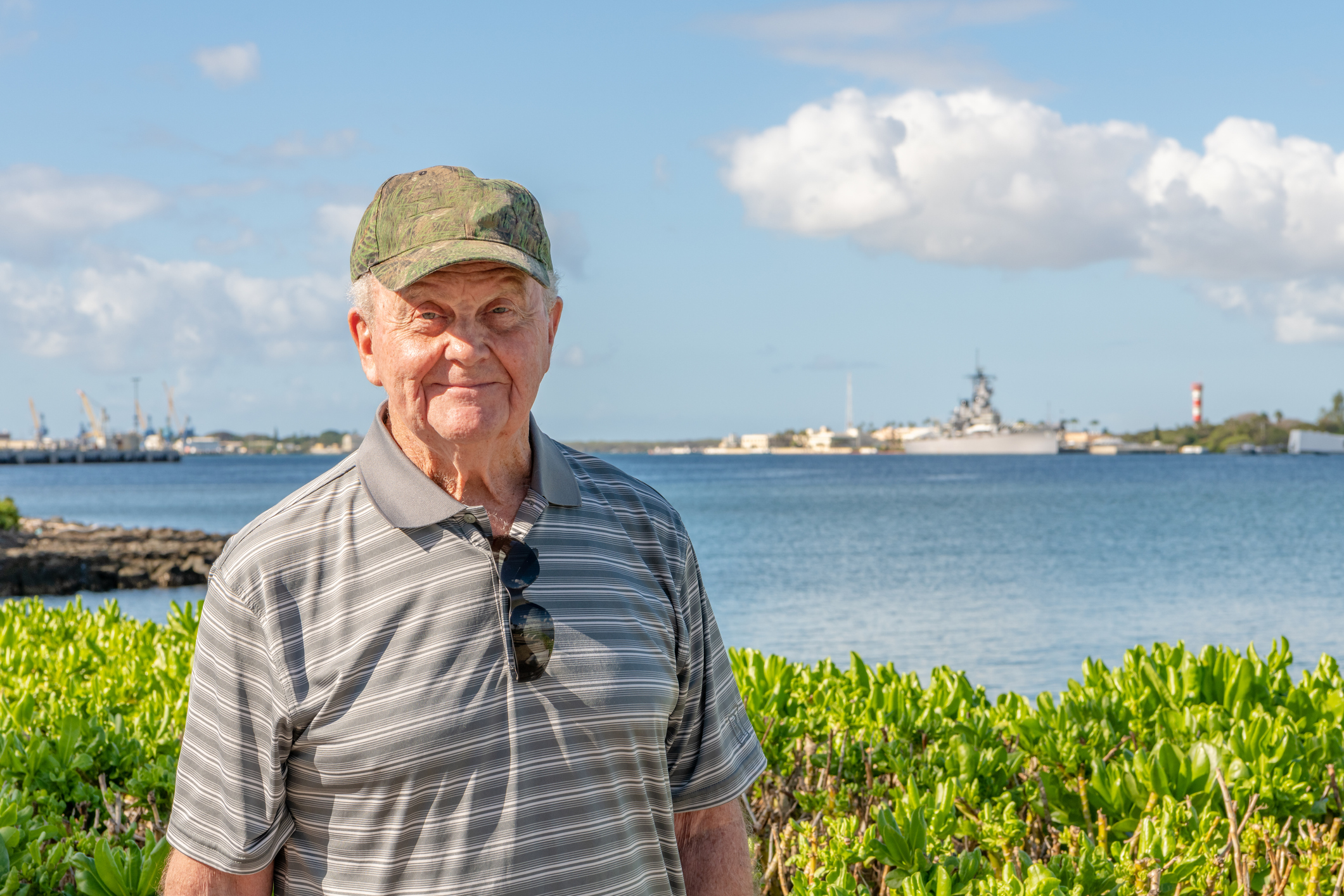A senior man, a veteran, poses happily outside