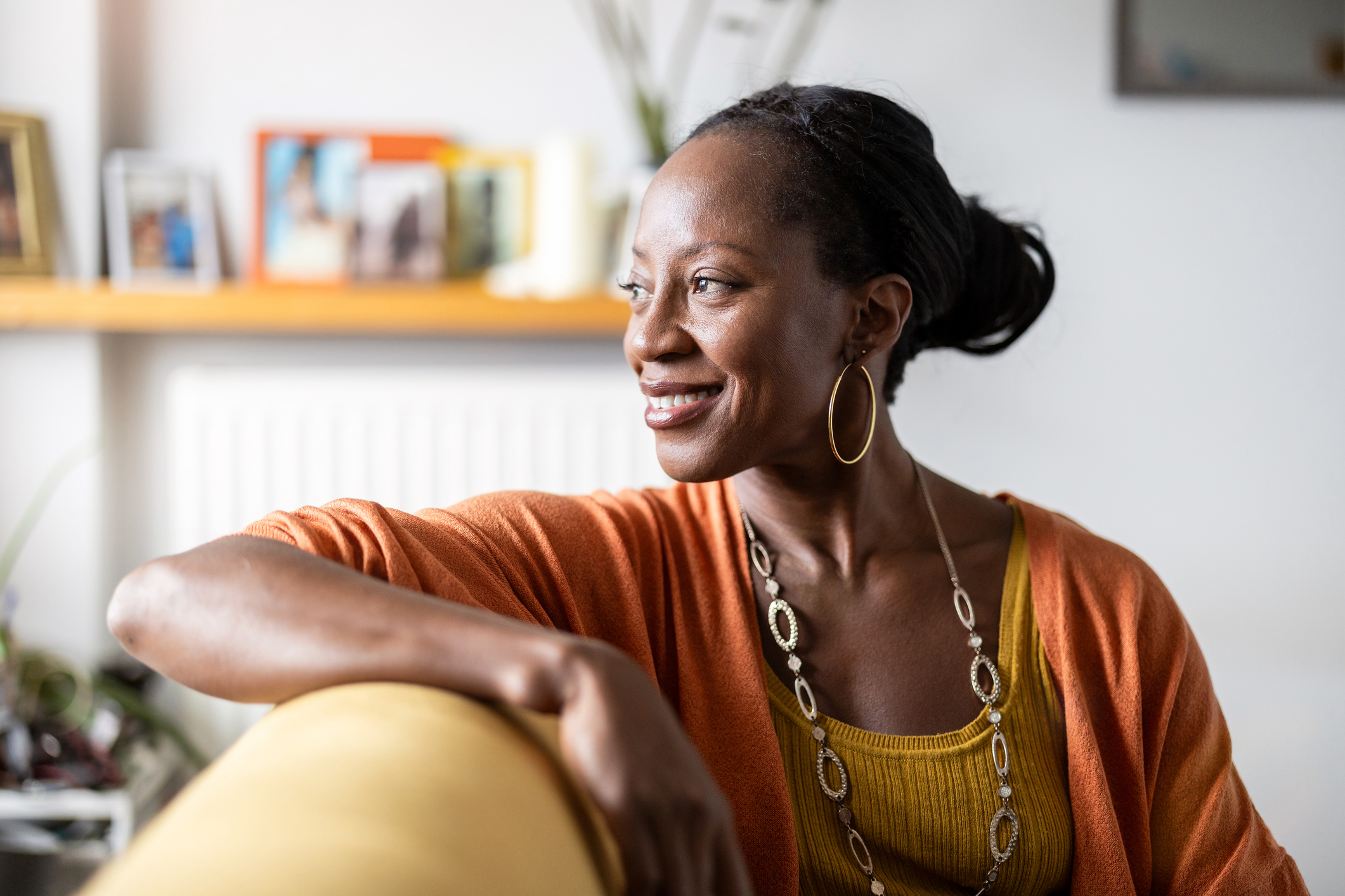 Smiling woman relaxing on sofa at home