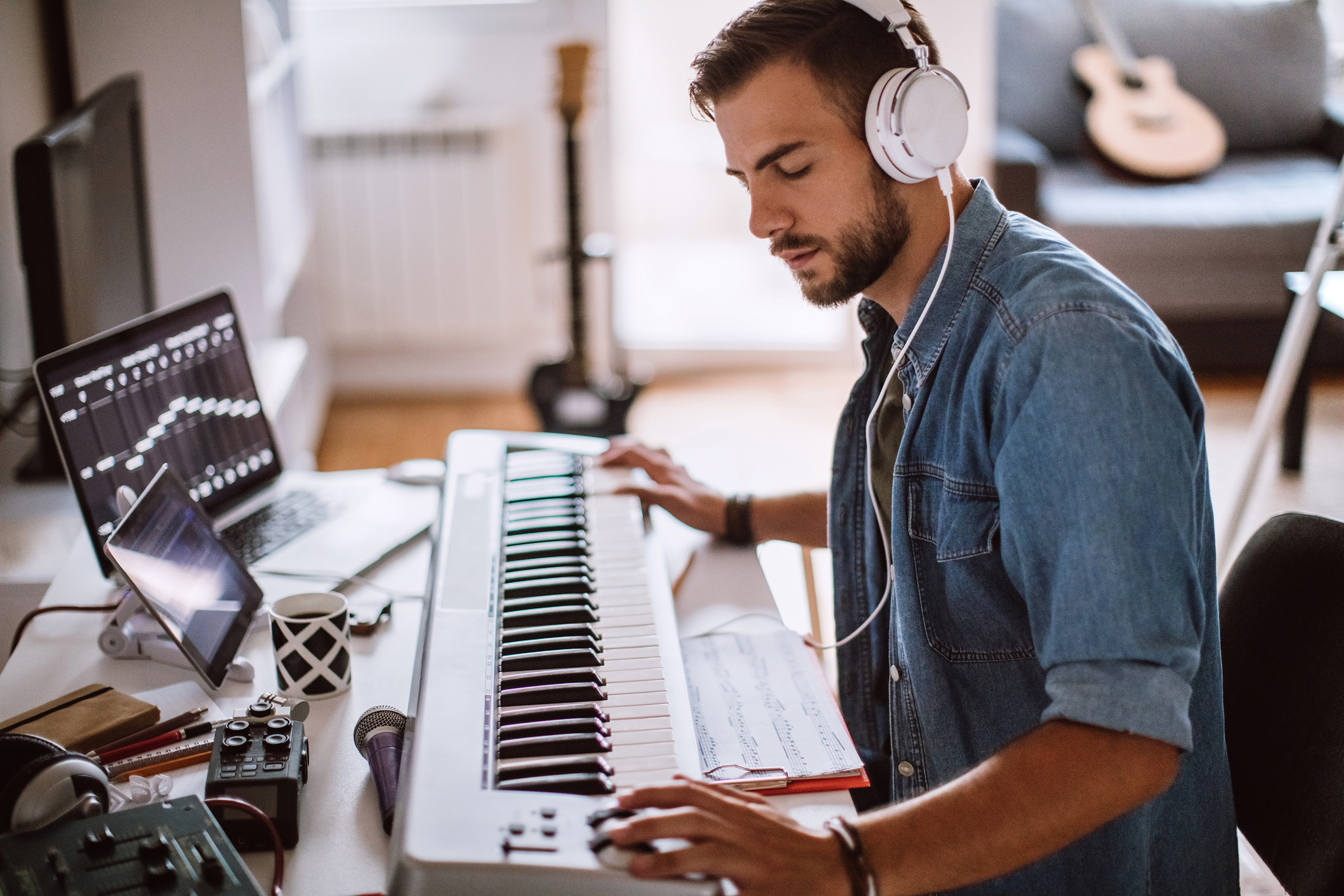 Focused musician plays music on keyboard piano