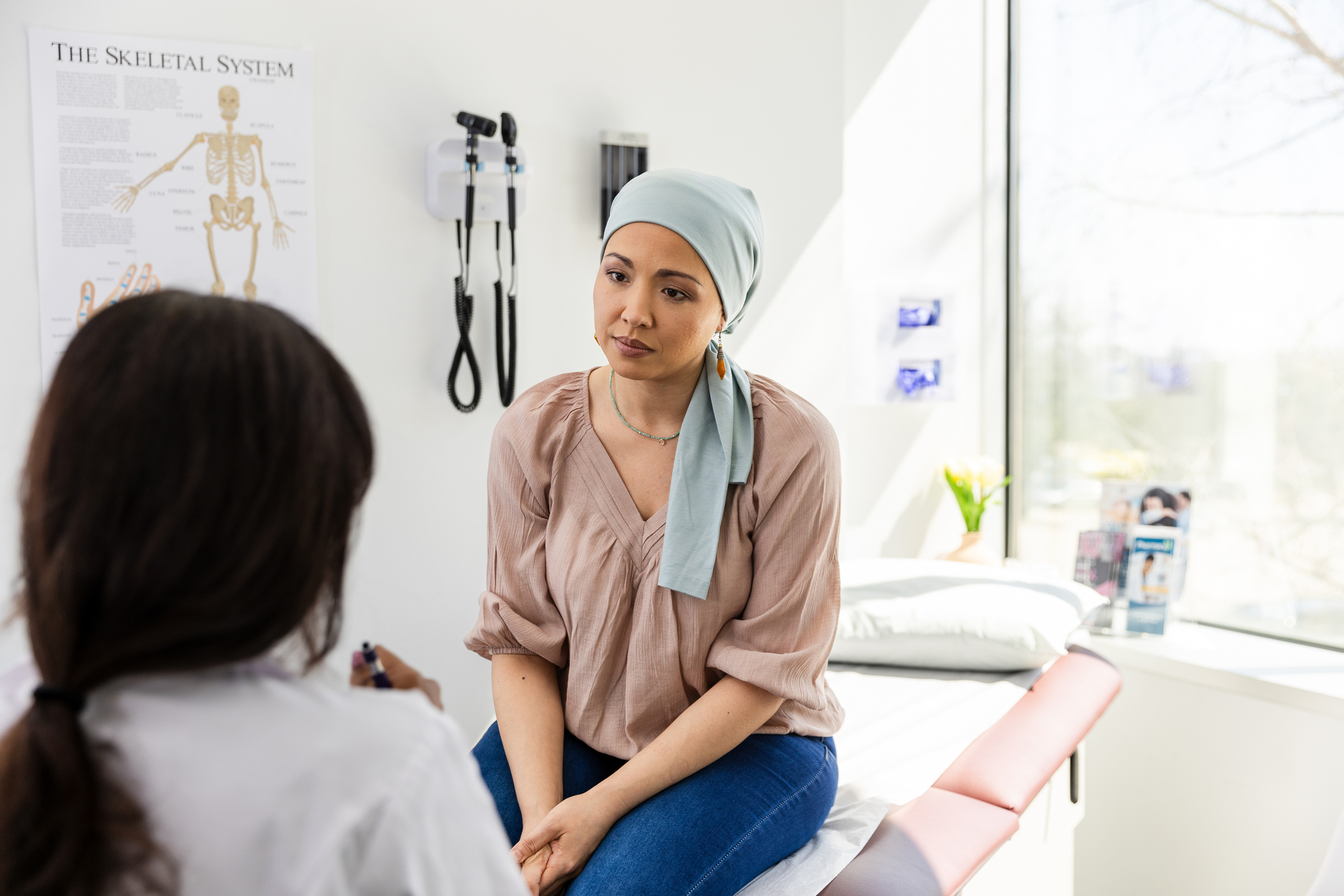 Young female patient listens carefully to doctor about her treatment.