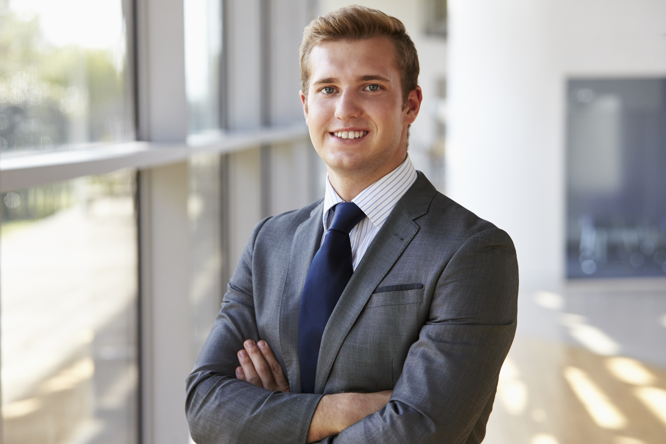 young smiling professional man, arms crossed