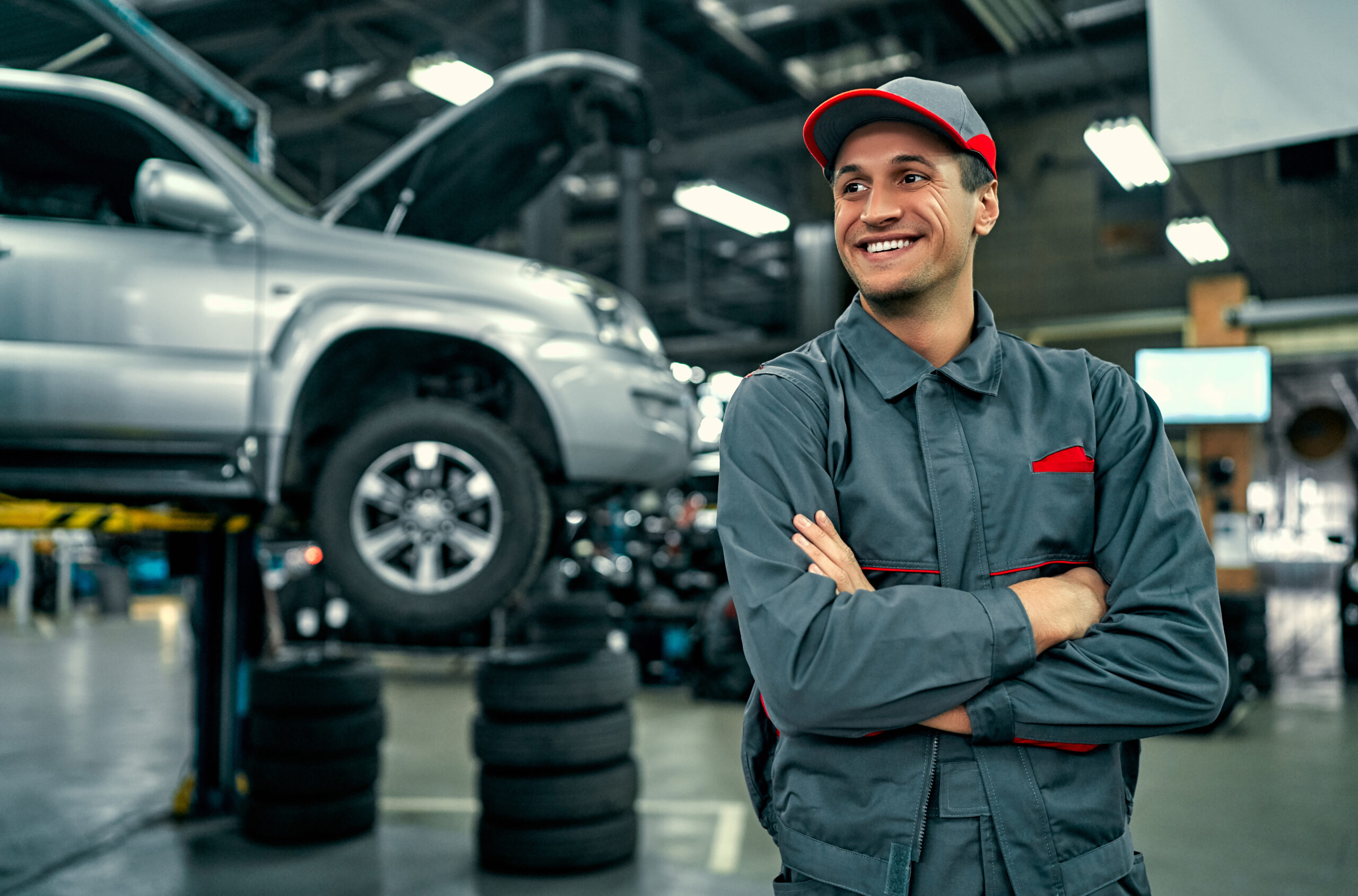Male mechanic poses confidently at auto shop