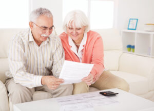 Senior couple with bills.