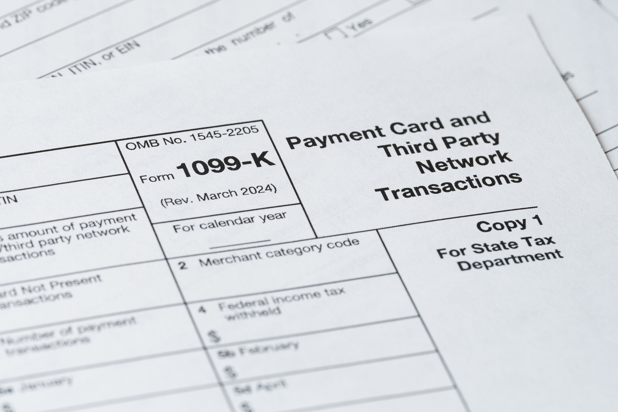 Close up of IRS tax forms 1099-K on a desk.