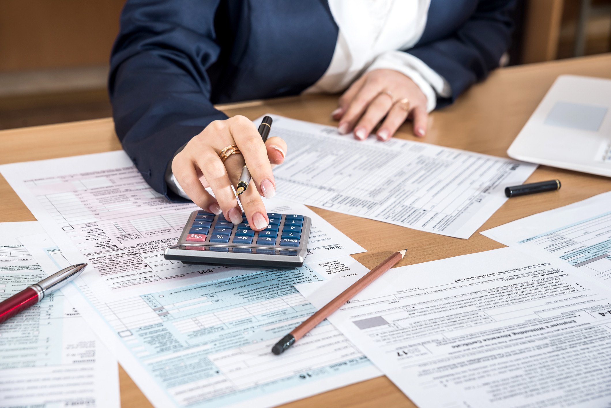 Woman working on tax returns and documents.