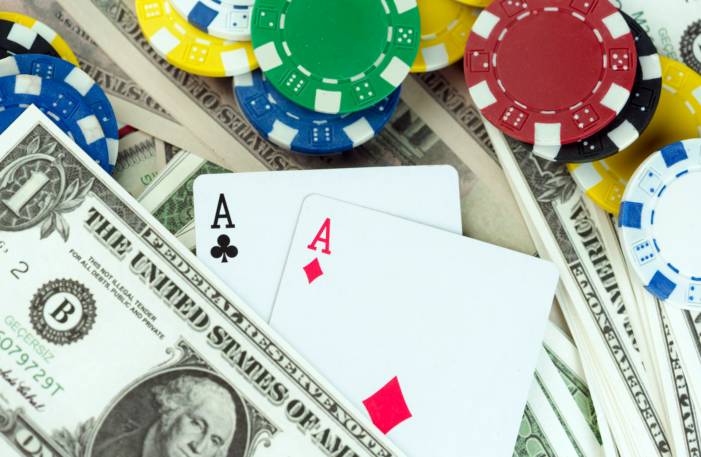 poker chips, playing cards, and cash spread out
